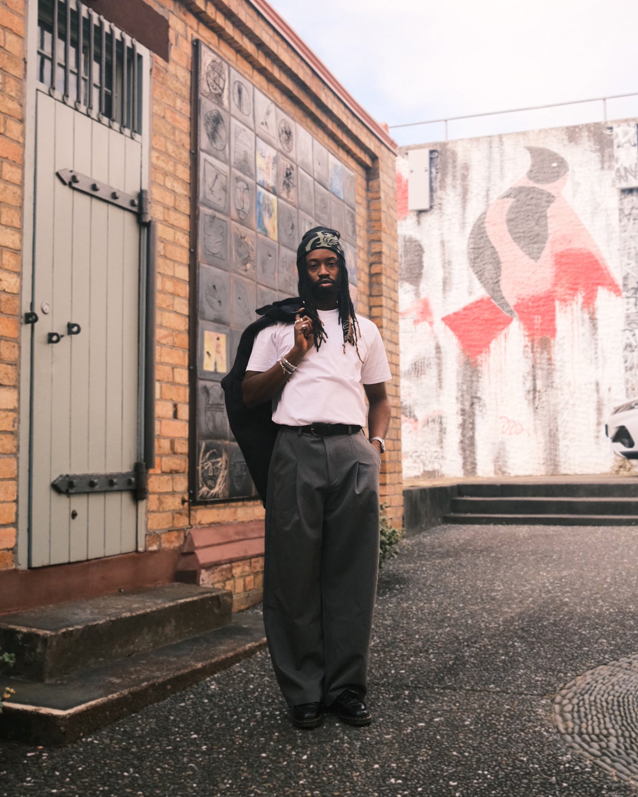 Iggy wearing the Wing Skull Beanie and VIC Double Pleated Pants — wide-leg, relaxed, baggy fit. Photographed on location in Auckland, New Zealand.