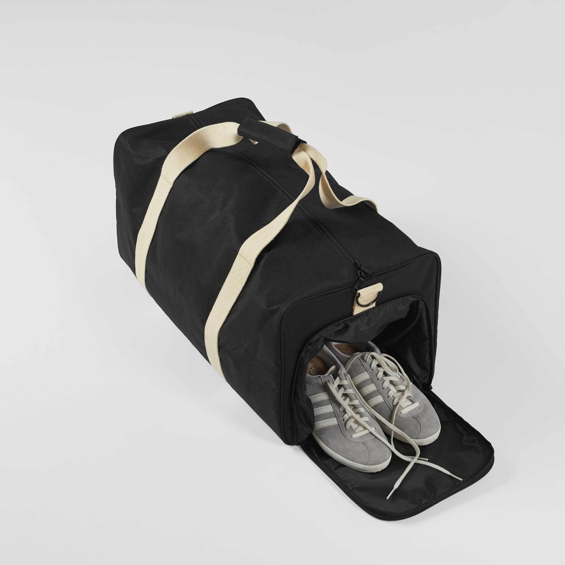 Meet our Travel Duffle Bag - the ultimate road trip companion! Made from 100% recycled polyester, this durable bag (28cm x 28cm x 58cm) features a signature shoe compartment for smart organization. With inner zip pockets, an external shoe compartment, and reliable YKK zips, travel hassle-free. Go eco-friendly without compromise. Get your versatile, eco-conscious Travel Duffle Bag today!