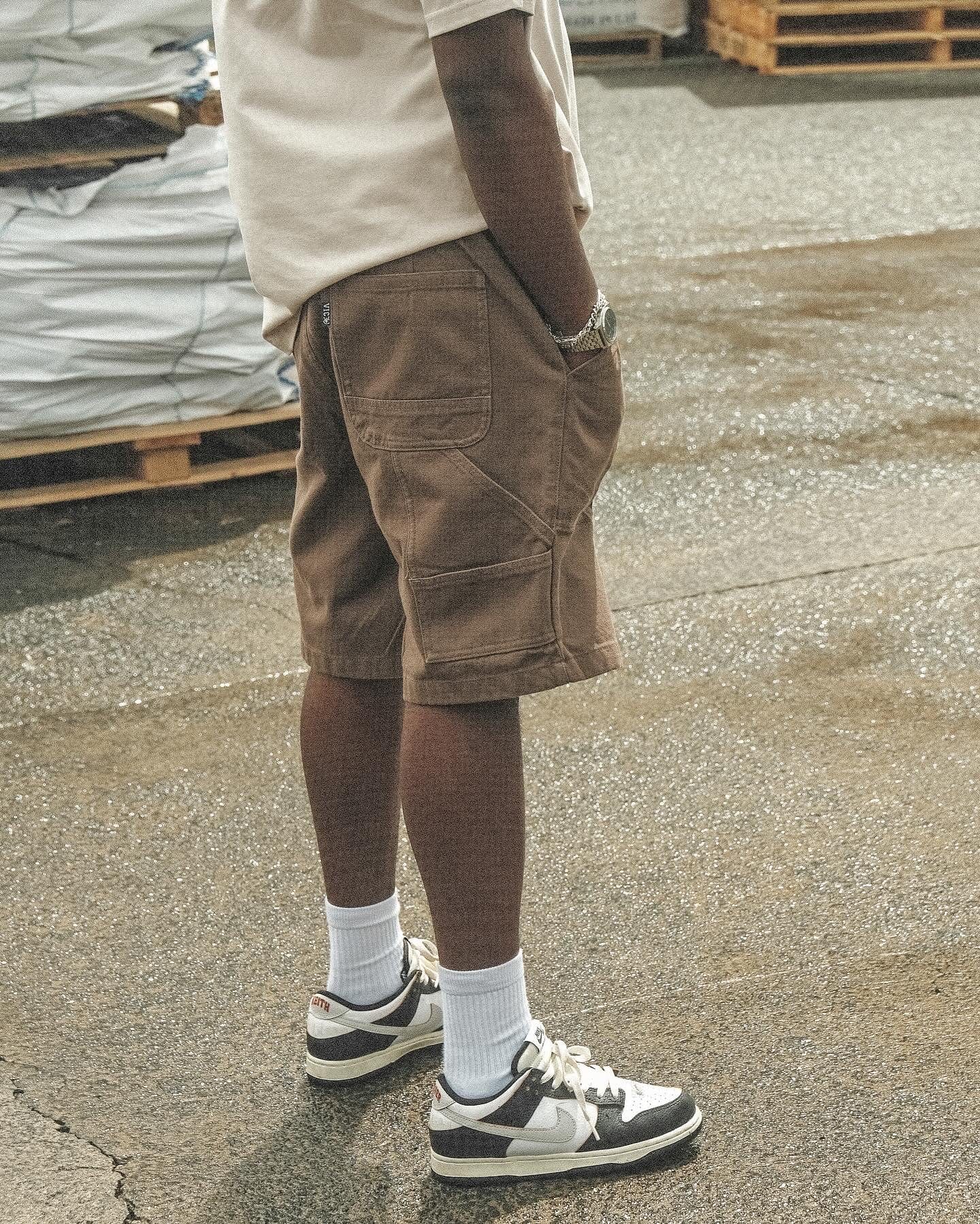 Discover our Canvas Work Shorts: vintage-inspired yet modern. Crafted from heavyweight 365 gsm cotton duck canvas, they offer a 90s retro style in a regular fit. Featuring a YKK zip fly, elastic back waistband, and VIC label flag, they're durable and comfortable. With 2 side pockets, 2 back pockets, and dual back pockets with a coin pocket, they're practical for work or leisure. Order up for a generous fit. Elevate your style with our Canvas Work Shorts!