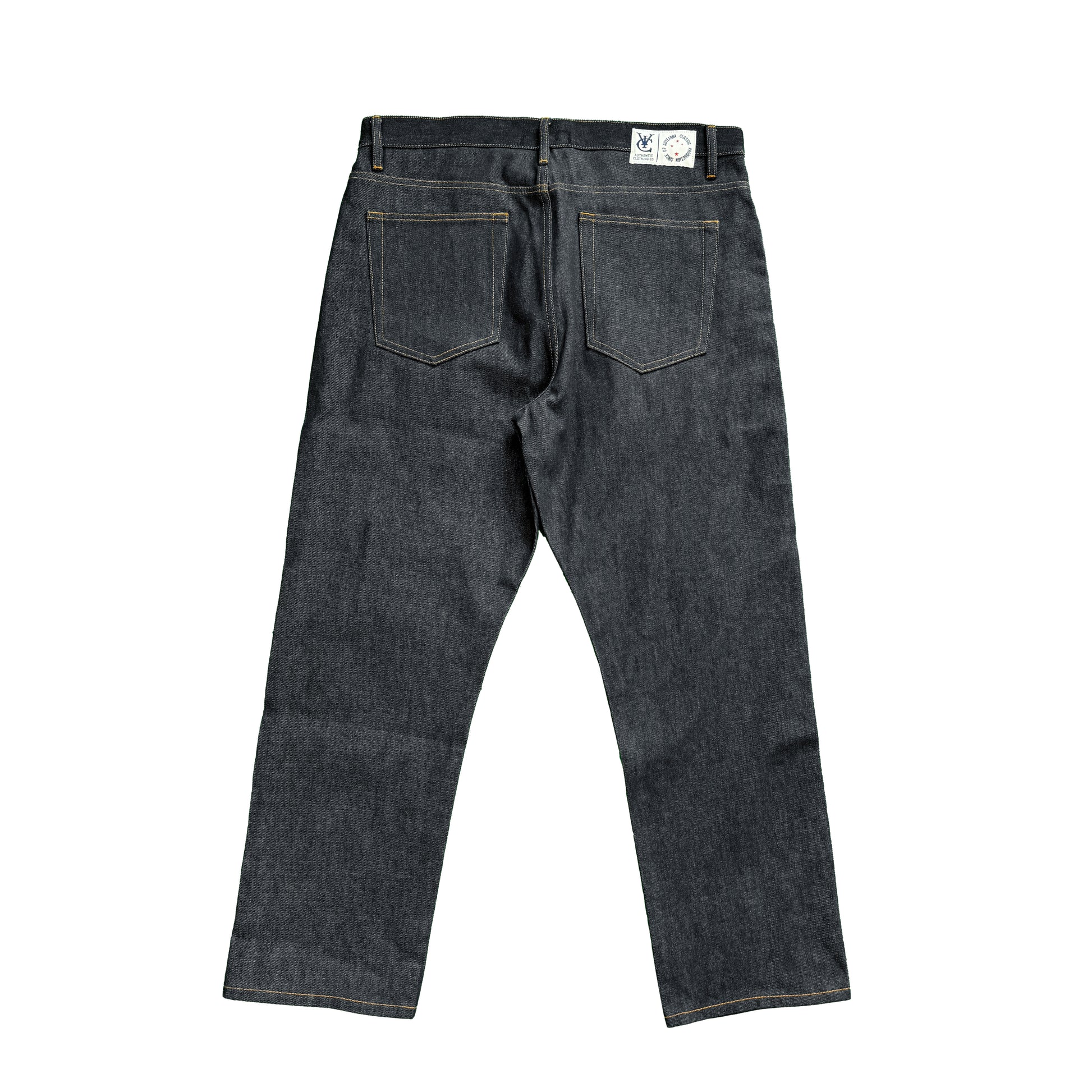 RAW SELVEDGE JEANS in dark indigo with a regular straight leg fit, cut from premium 15oz raw selvedge denim. Finished with contrast stitching, selvedge detail on the coin pocket, and a VIC woven patch on the waistband. Inspired by vintage Japanese selvedge denim and reimagined with a modern silhouette.