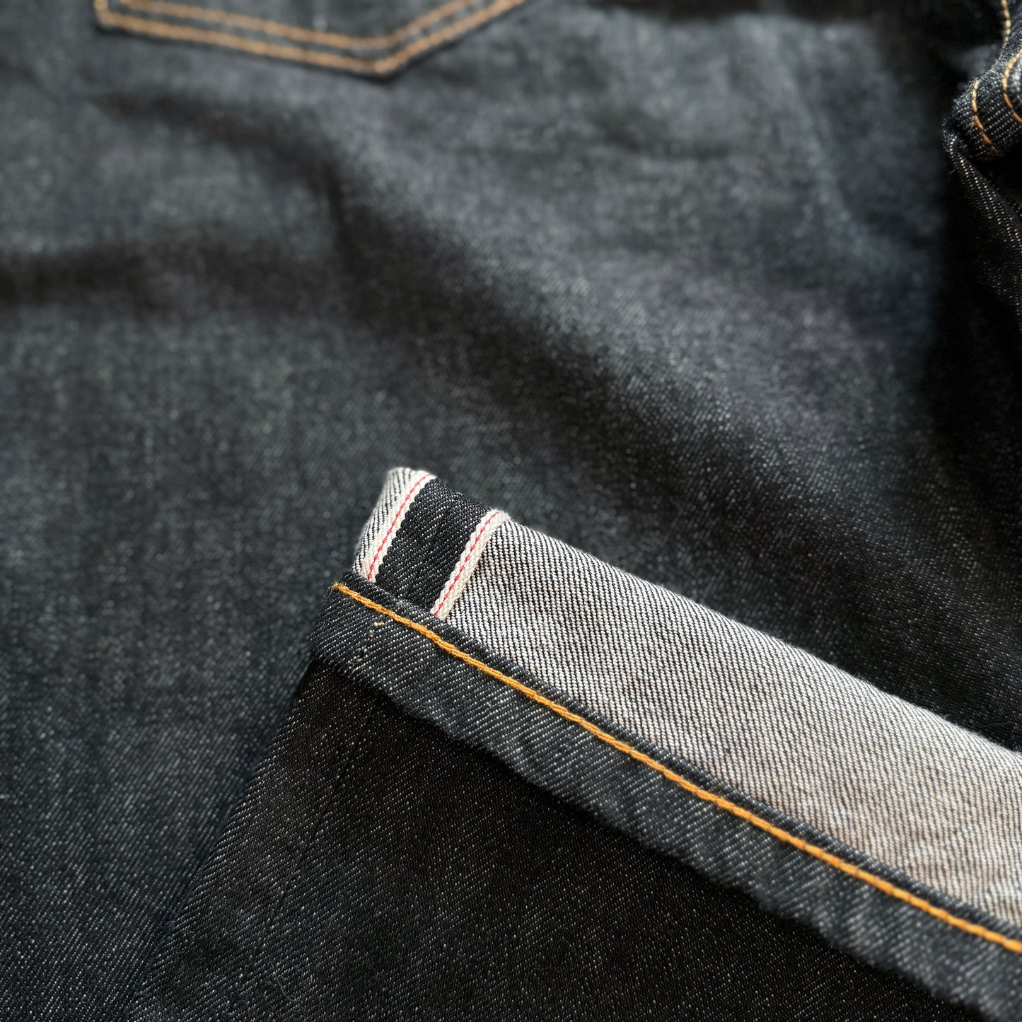 SELVEDGE JEANS in black wash with a regular straight leg fit, made from premium 14.25oz selvedge denim. Designed with contrast stitching, selvedge detail on the coin pocket, and finished with a VIC woven patch on the waistband.