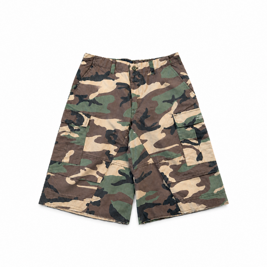 Woodland camo cargo shorts with a relaxed, below-knee fit and raw hems