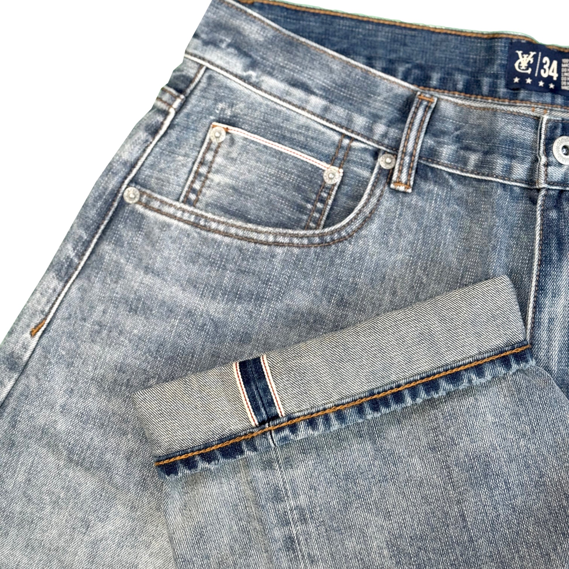Baggy fit selvedge jean in 14.5oz denim with a vintage sandblasted treatment. Roomy thigh with tapered cuff. Detailed with selvedge accents on the coin pocket and a Jacron paper label patch on the waistband.