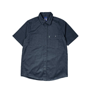 The short sleeve Workwear Shirt is a staple that has been designed to carry you through any occasion.  A workwear inspired garment with functional pockets and a structured, regular fit. Featuring a custom woven label on the left chest pocket. A high-quality shirt that has been made to last, with a timeless sense of style. Wear buttoned up or layered over tees. 